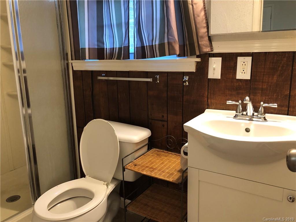 726 Valleydale Road Charlotte, NC 28214 - Photo 10 of 32 a bathroom with a toilet a sink and mirror
