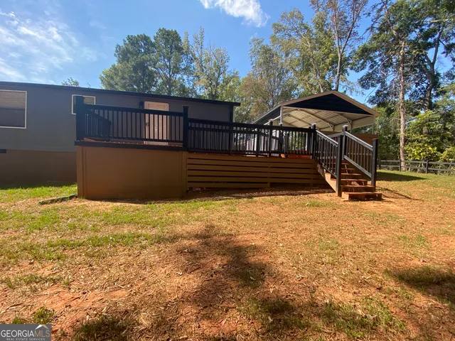 a view of a yard with wooden fence