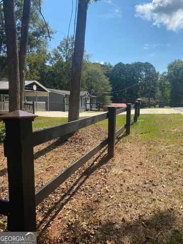 a view of a yard with large trees