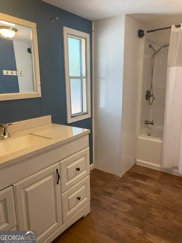 a view of walk in closet with wooden floor