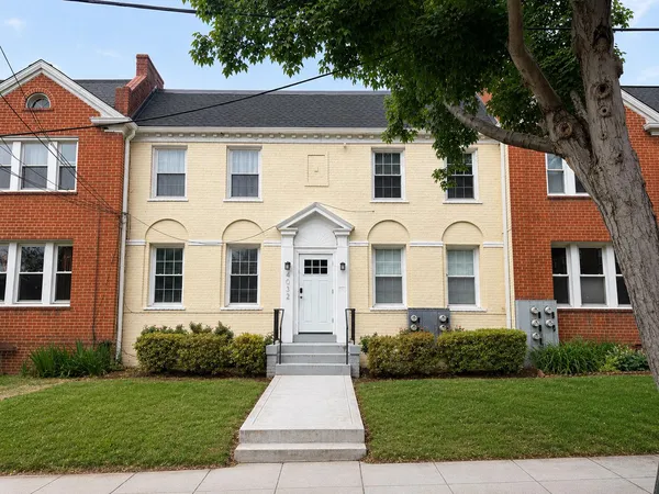 a front view of a house with a yard