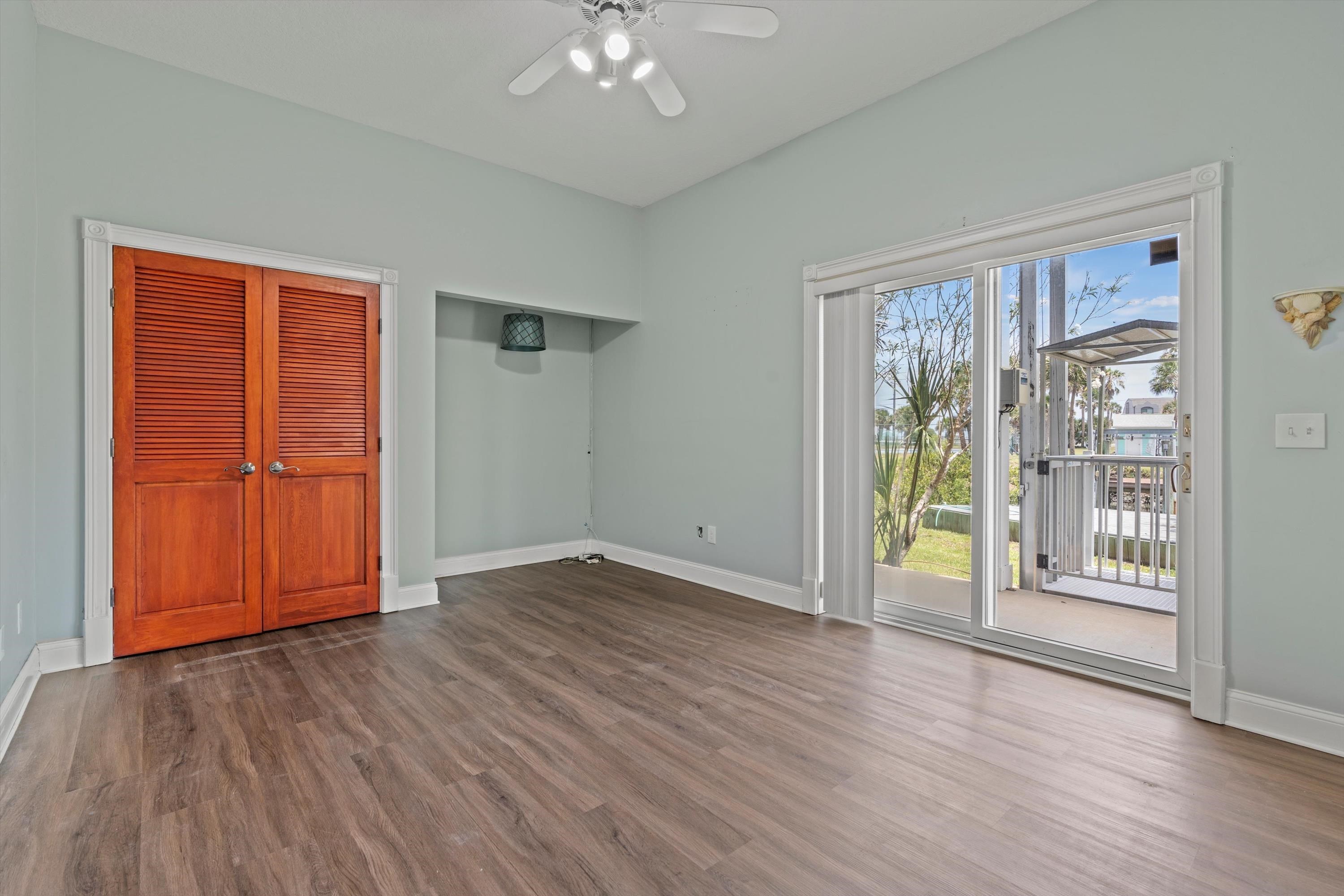 231 Barrataria Drive St. Augustine, FL 32080 - Photo 18 of 43 an empty room with wooden floor closet and windows