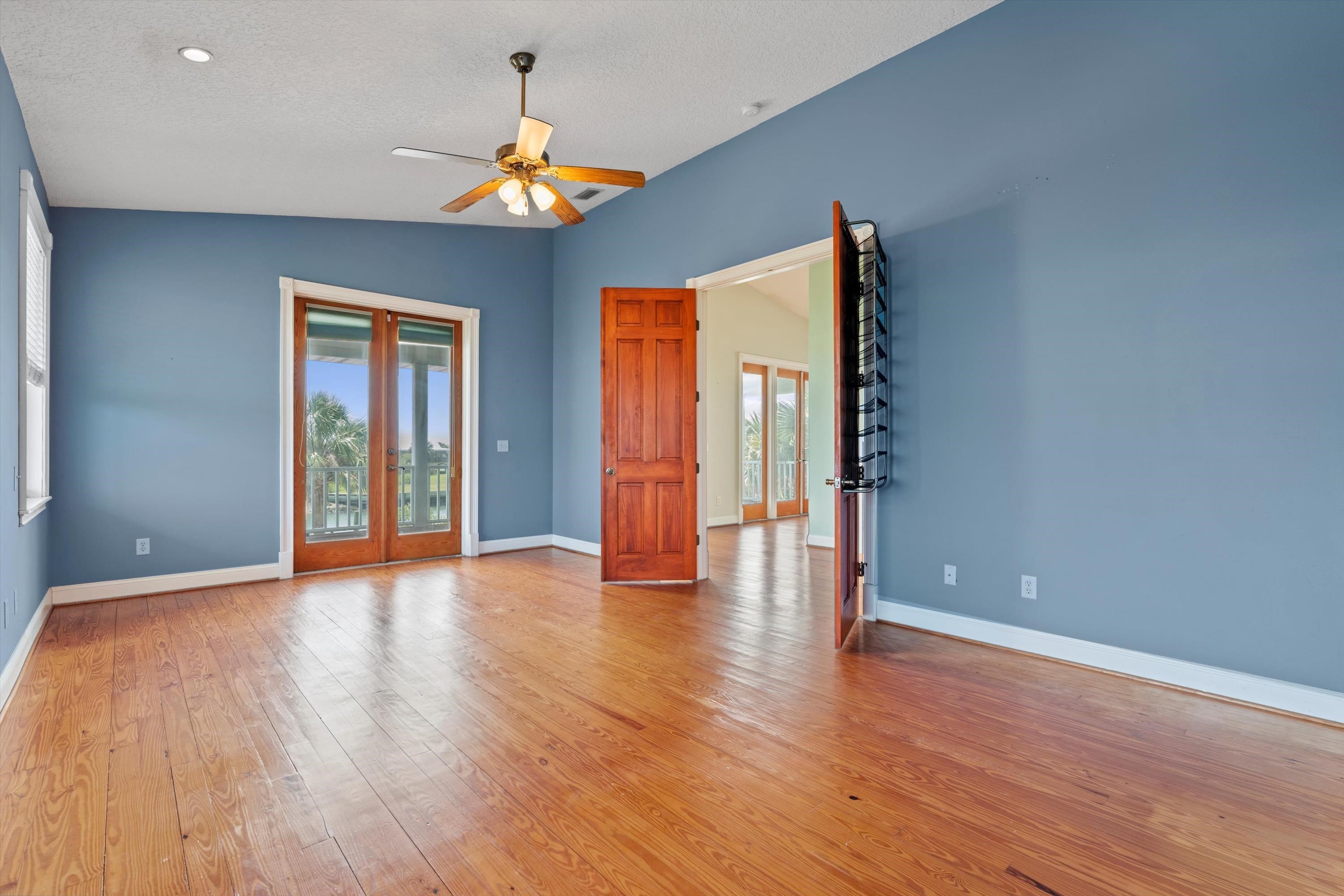 231 Barrataria Drive St. Augustine, FL 32080 - Photo 25 of 43 a view of an empty room with wooden floor and a window