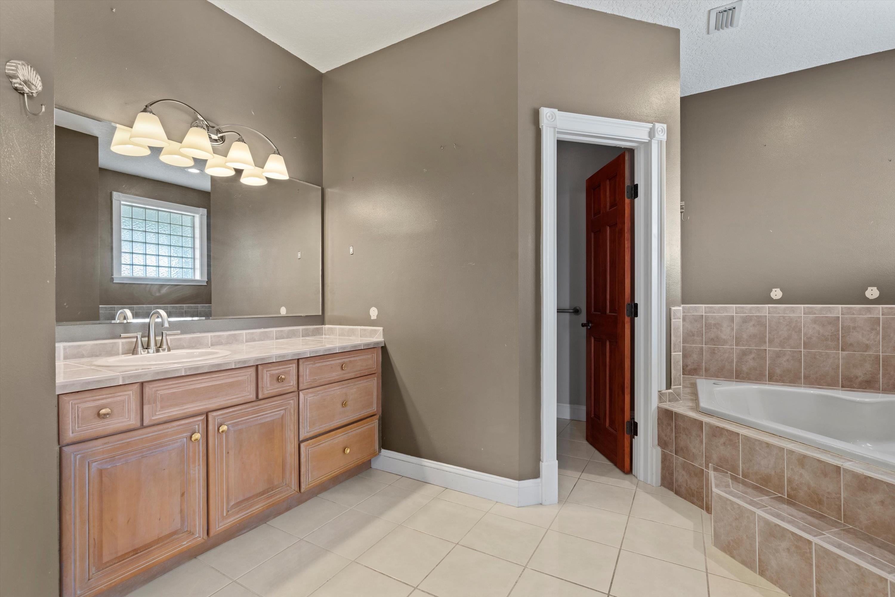231 Barrataria Drive St. Augustine, FL 32080 - Photo 27 of 43 a bathroom with a double vanity sink and a mirror