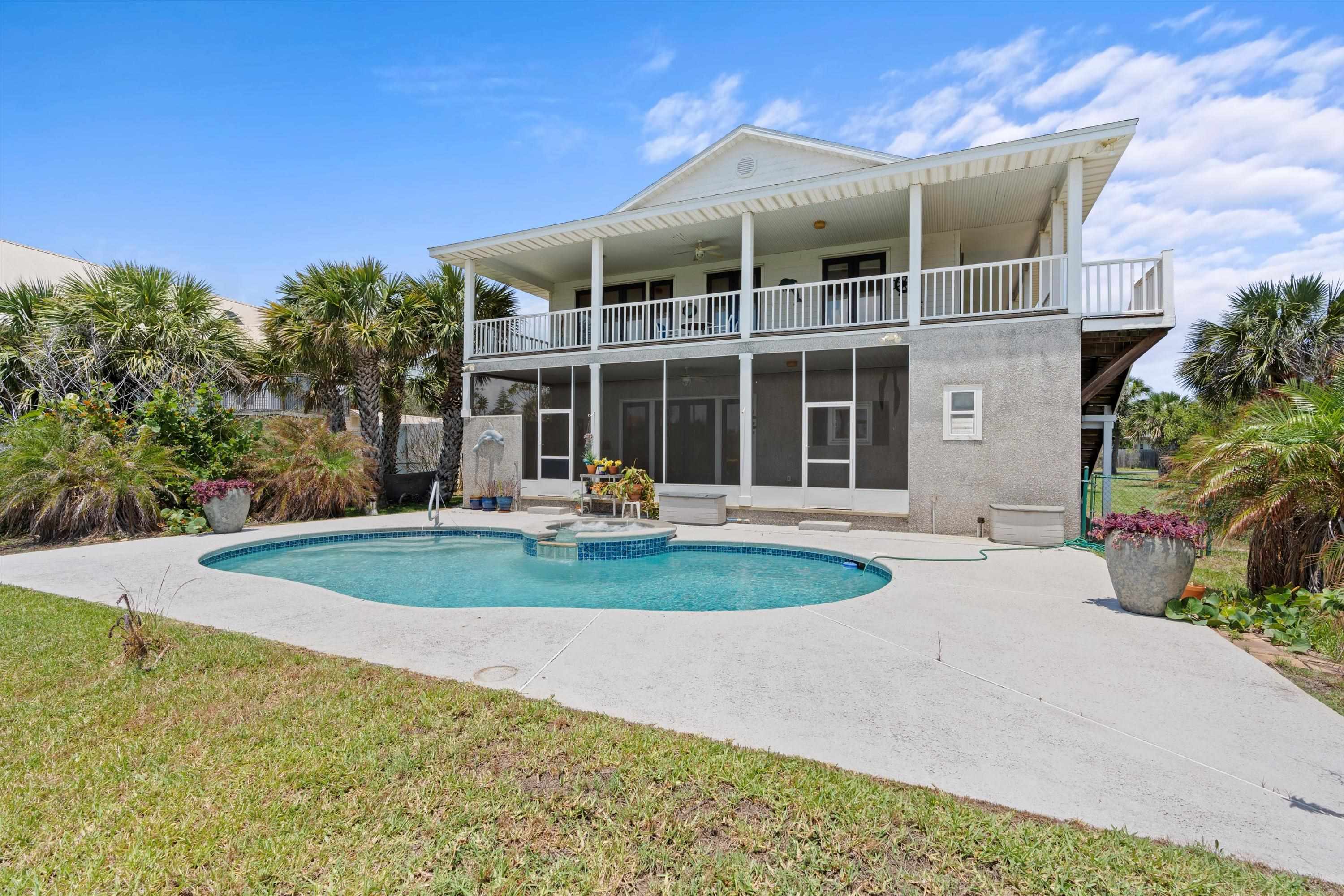 231 Barrataria Drive St. Augustine, FL 32080 - Photo 35 of 43 a front view of a house with a yard and potted plants