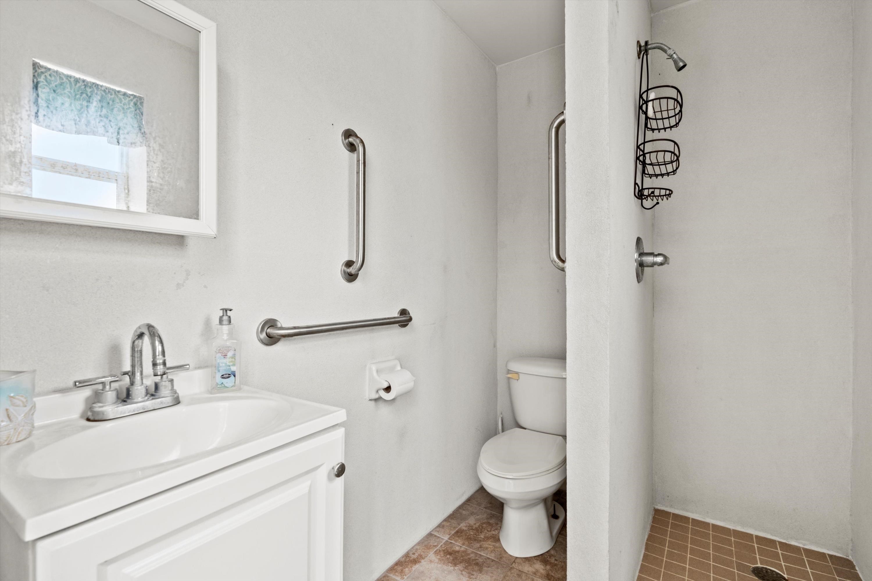231 Barrataria Drive St. Augustine, FL 32080 - Photo 37 of 43 a bathroom with a toilet sink vanity and mirror