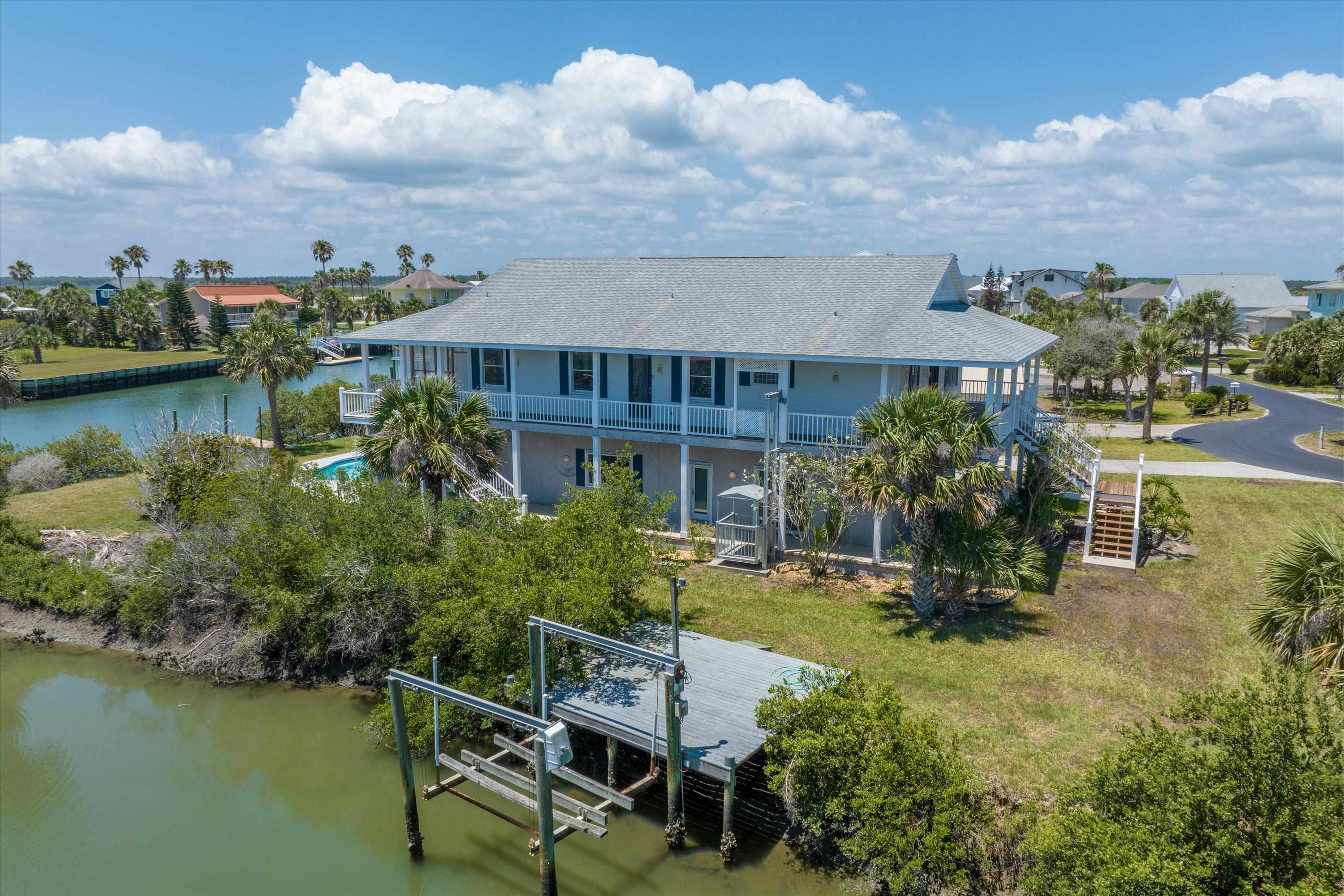 231 Barrataria Drive St. Augustine, FL 32080 - Photo 6 of 43 an aerial view of a house with swimming pool garden and lake view