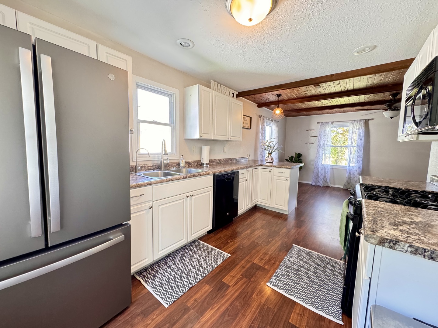 1087 Lost Nation Road Dixon, IL 61021 - Photo 5 of 23 a kitchen with a refrigerator a sink and wooden floor