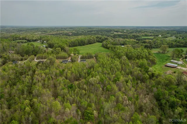 an aerial view of forest with houses
