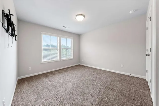 a bathroom with a granite countertop sink and a toilet