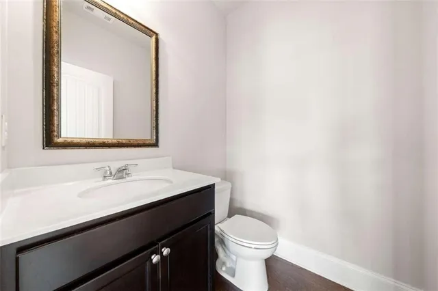 a bathroom with a sink a toilet and mirror