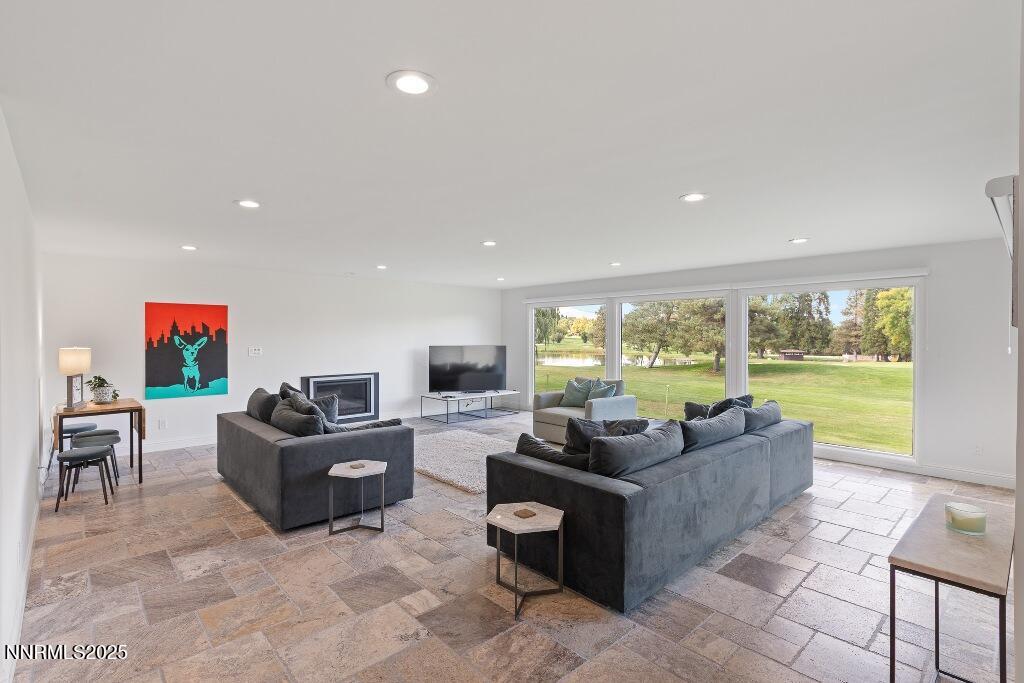 4811 Lakeridge Terrace West Reno, NV 89509 - Photo 11 of 43 a living room with fireplace furniture and a large window