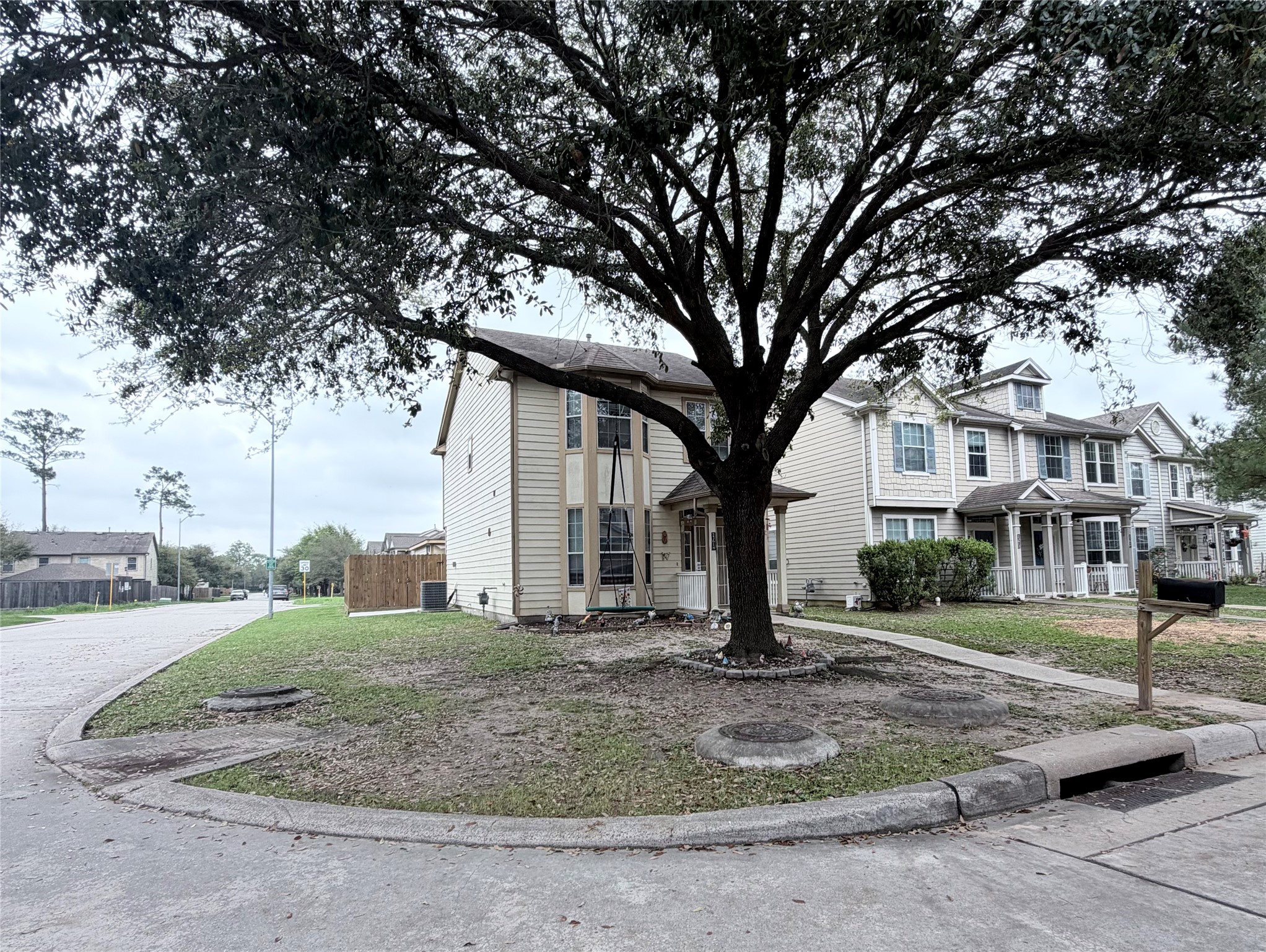 23614 Wildwood Green Way Spring, TX 77373 - Photo 1 of 27 a tree in front of a white house