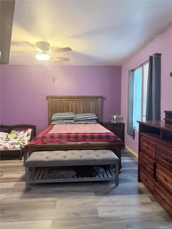 a bedroom with a bed closet and flat tv screen