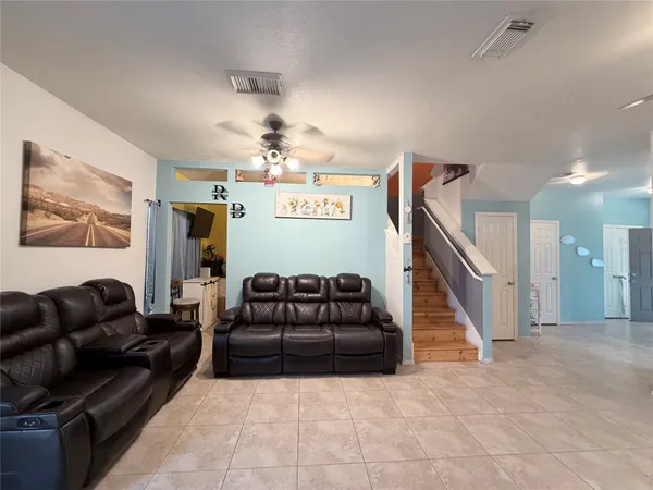 a living room with furniture and stairs