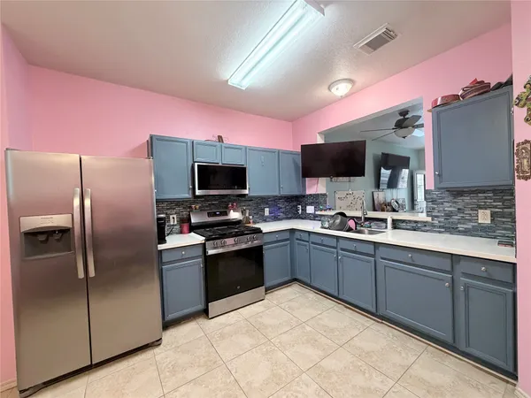 a kitchen with granite countertop stainless steel appliances and sink