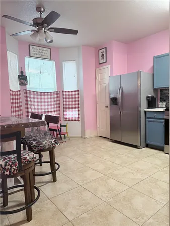a kitchen with furniture a refrigerator and a table