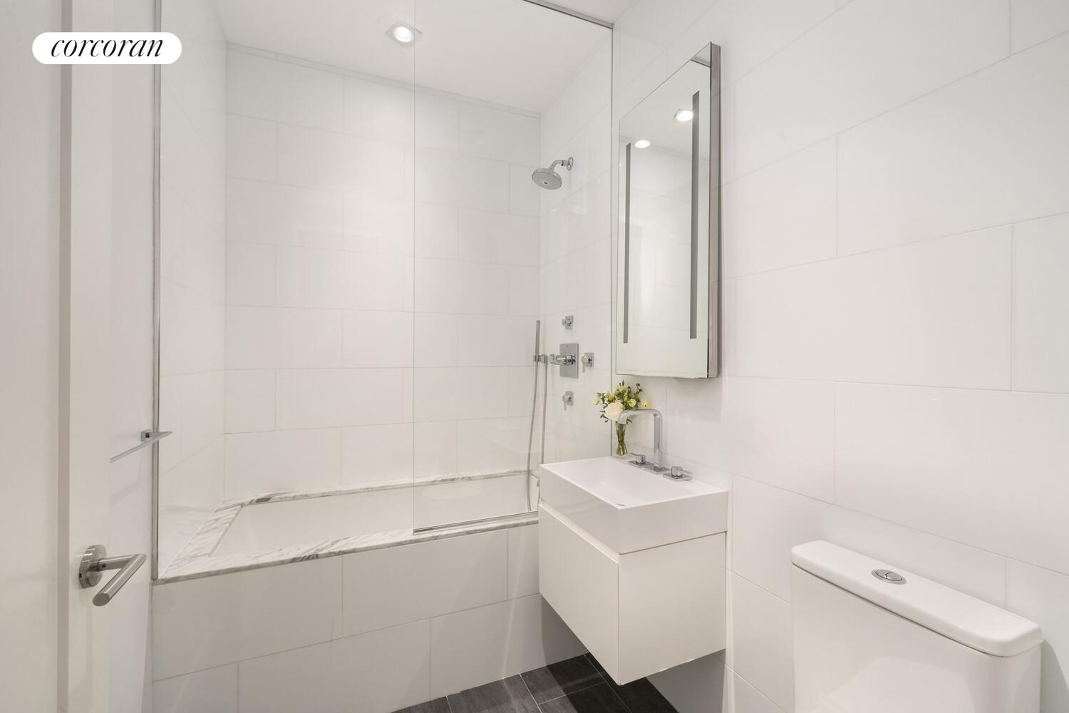 290 West Street, Unit 3A Manhattan, NY 10013 - Photo 12 of 21 a bathroom with a sink a toilet and shower