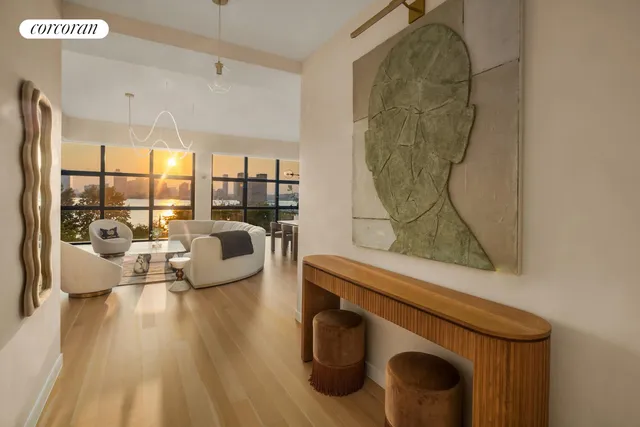 a living room with furniture and a floor to ceiling window