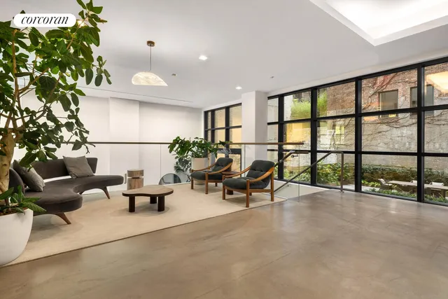 a living room with furniture and a potted plant