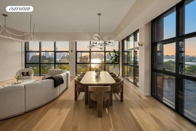a living room with furniture a flat screen tv and a floor to ceiling window