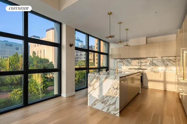a view of a kitchen with furniture and large windows