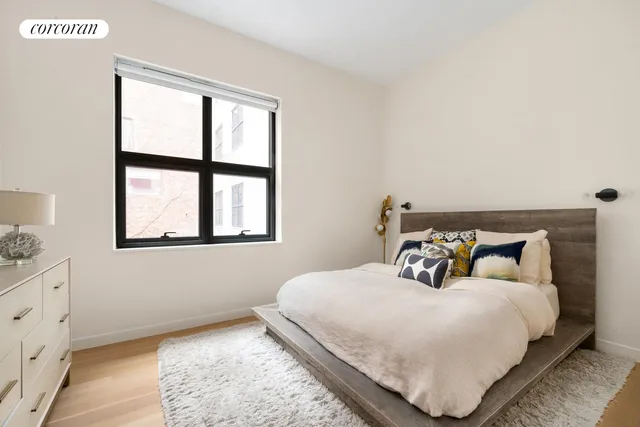 a bedroom with a bed and window