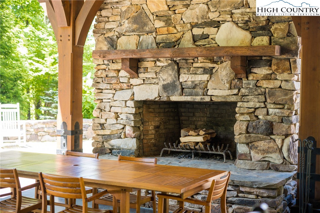 13 August Lily Lane Boone, NC 28607 - Photo 25 of 29 a dining room with fireplace and wooden floor