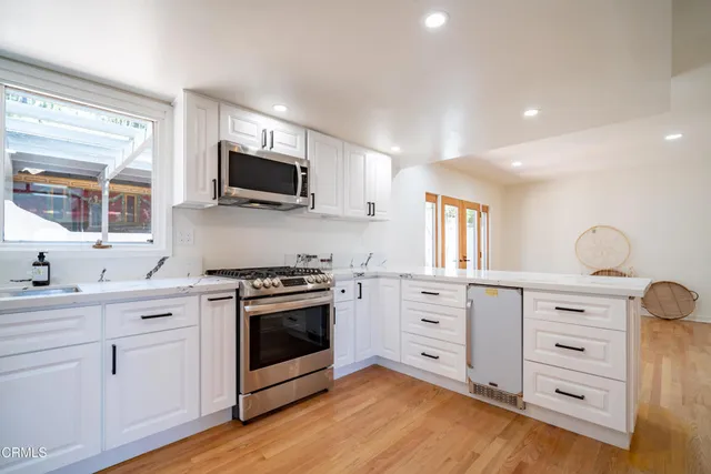 a kitchen with stainless steel appliances granite countertop a stove and a sink