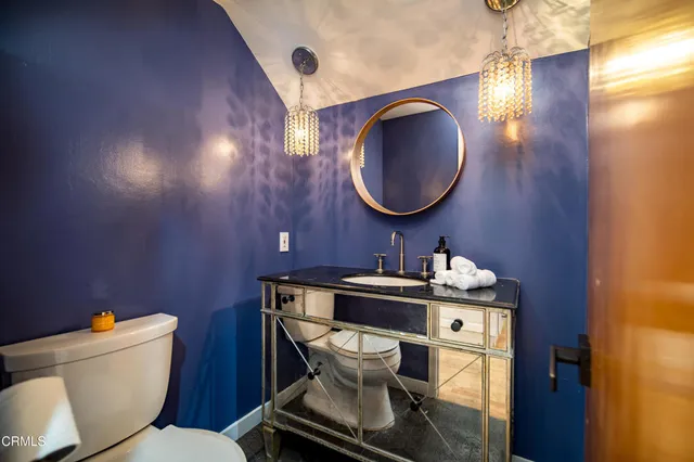 a bathroom with a toilet a sink and mirror