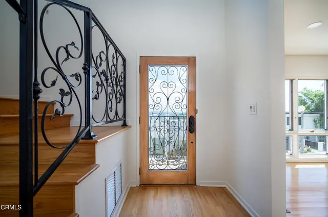 a view of an entryway with wooden floor