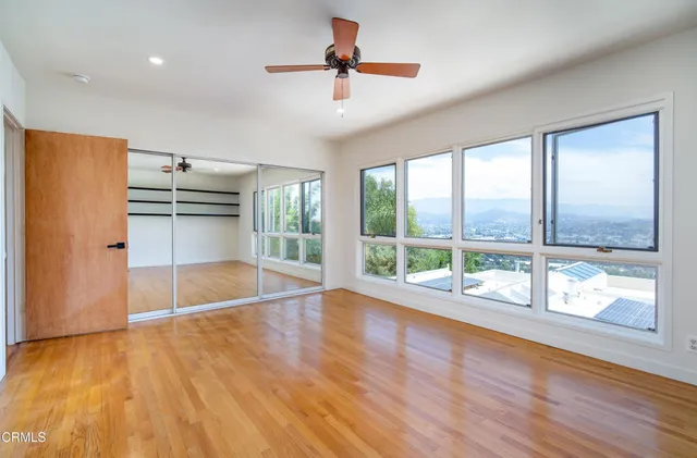 a view of a livingroom with a ceiling fan and window