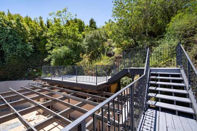 a view of balcony with wooden floor and fence