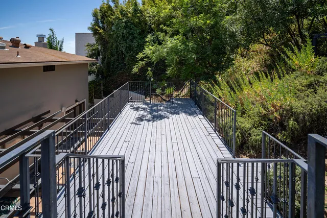 a view of a house with backyard and deck