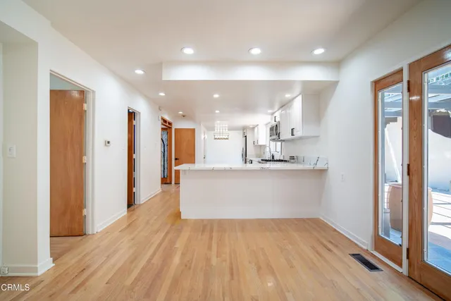 a view of kitchen with stainless steel appliances refrigerator oven and cabinets