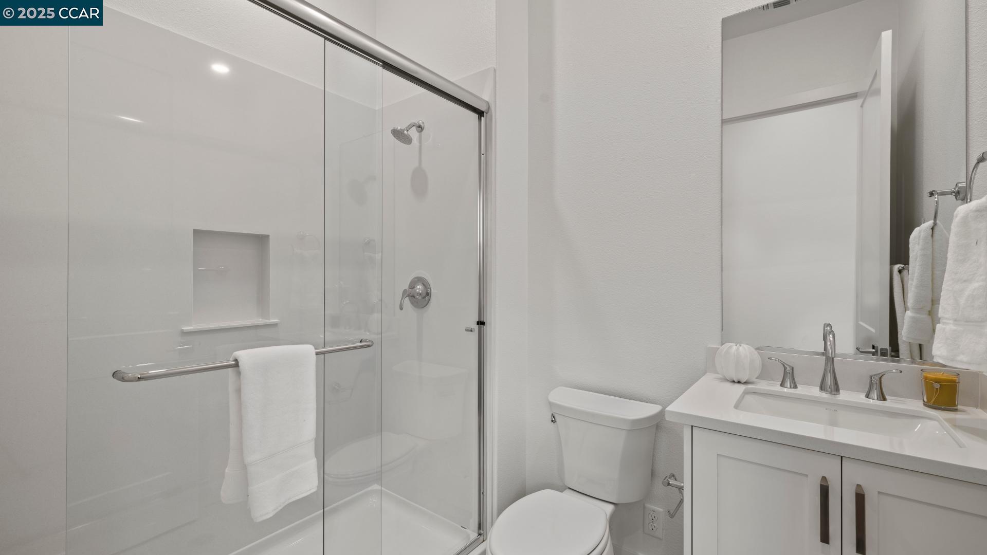 1634 Granite Place Tracy, CA 95377 - Photo 7 of 28 a bathroom with a granite countertop sink toilet and shower