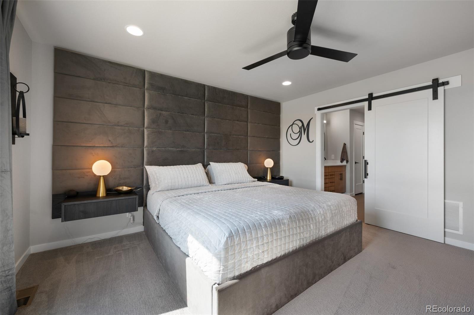 3563 Mission Bay Court Colorado Springs, CO 80922 - Photo 11 of 48 a bedroom with a bed and a chandelier