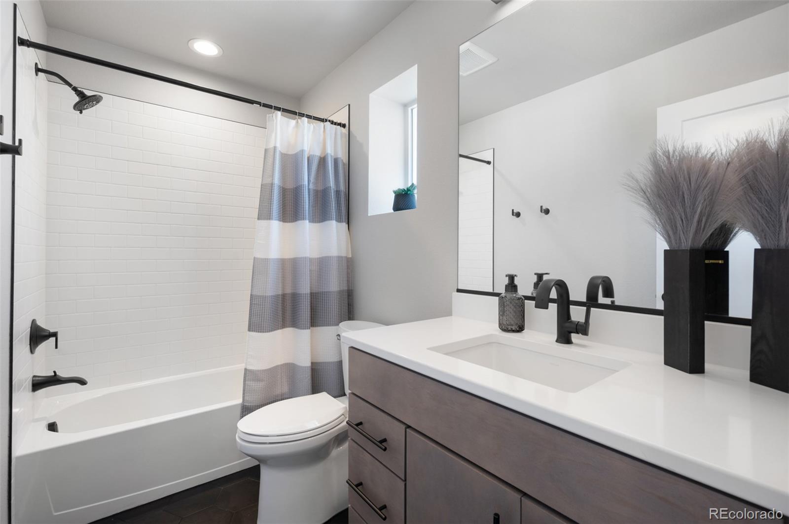 3563 Mission Bay Court Colorado Springs, CO 80922 - Photo 15 of 48 a bathroom with a sink a toilet and shower