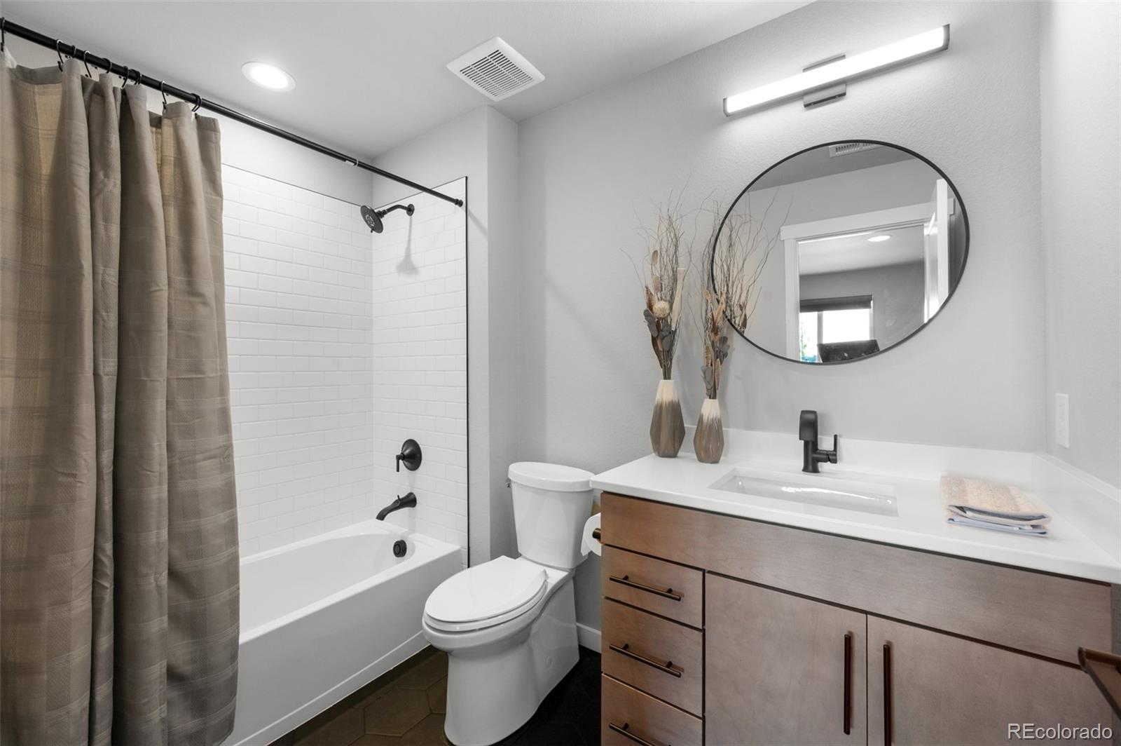 3563 Mission Bay Court Colorado Springs, CO 80922 - Photo 18 of 48 a bathroom with a sink toilet and shower