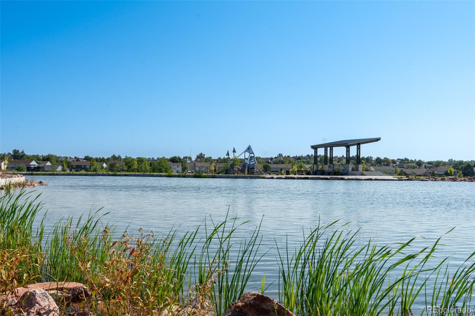 3563 Mission Bay Court Colorado Springs, CO 80922 - Photo 23 of 48 a view of a lake with a mountain in the background