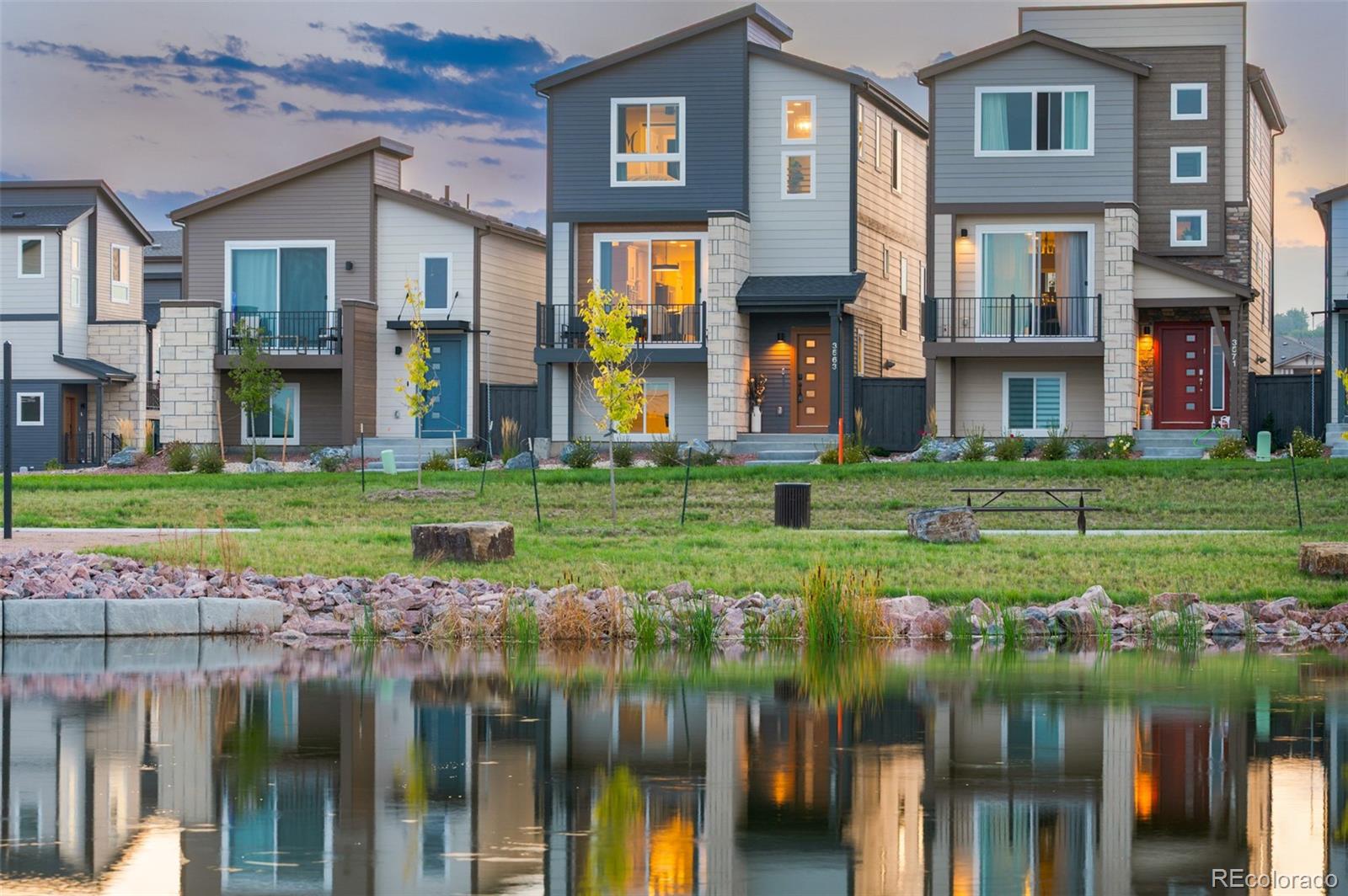 3563 Mission Bay Court Colorado Springs, CO 80922 - Photo 27 of 48 a front view of a residential apartment building with a yard