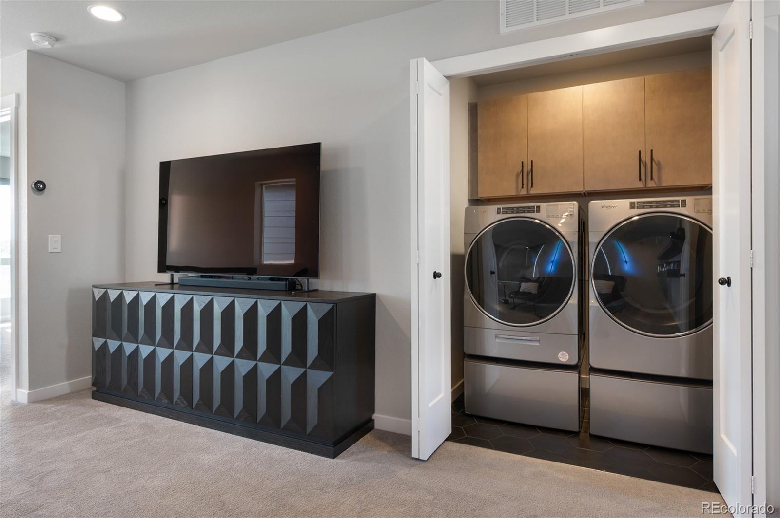 3563 Mission Bay Court Colorado Springs, CO 80922 - Photo 37 of 48 a view of a livingroom with a washer and dryer