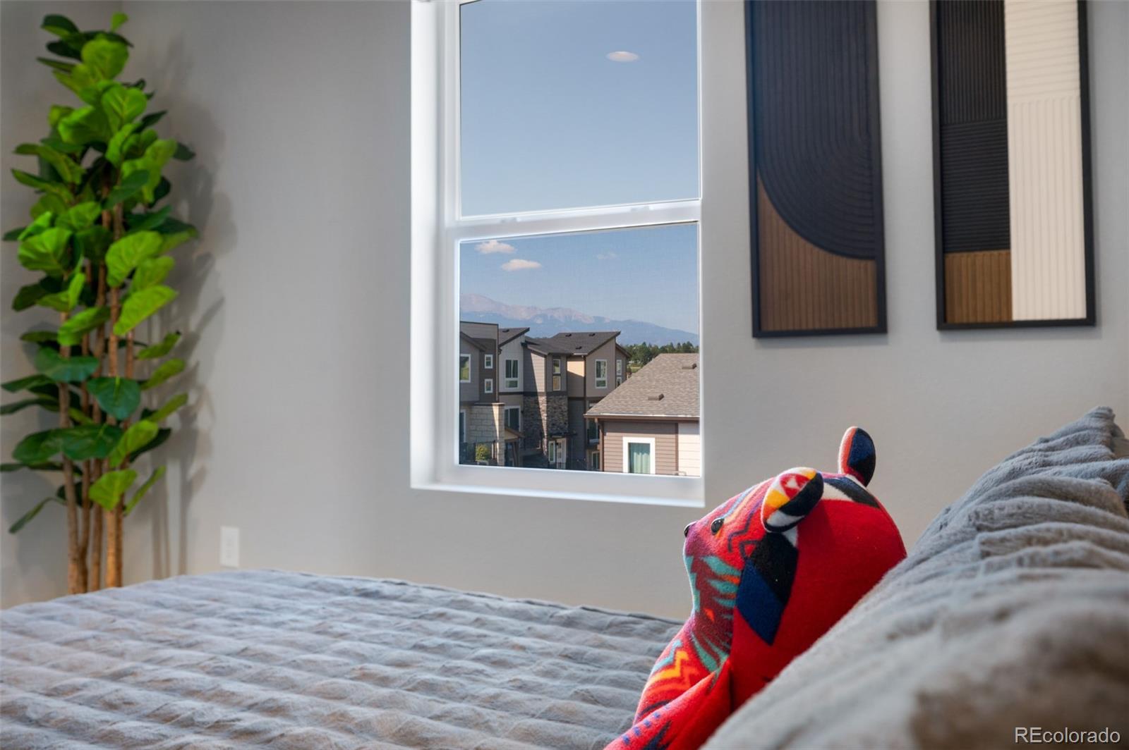 3563 Mission Bay Court Colorado Springs, CO 80922 - Photo 43 of 48 a bedroom with a bed and a potted plant