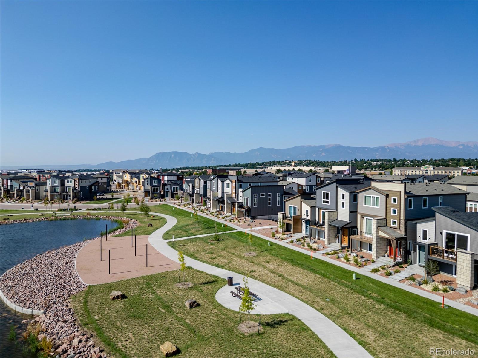 3563 Mission Bay Court Colorado Springs, CO 80922 - Photo 46 of 48 a view of a lake with a house