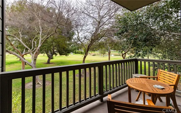 a view of a two chairs in the balcony