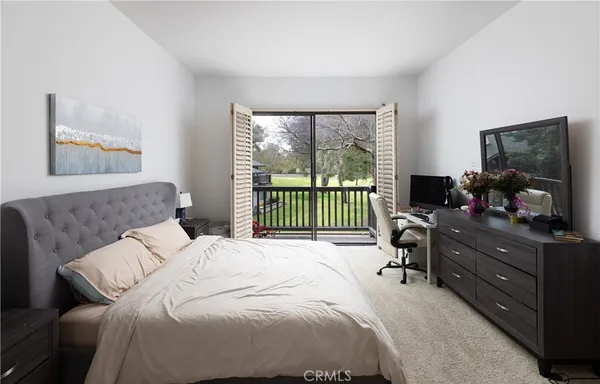 a bedroom with a bed and a television