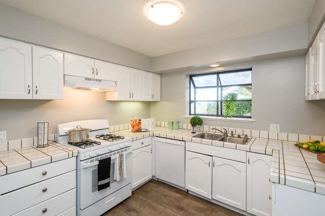 601 Sharp Park Road Pacifica, CA 94044 - Photo 7 of 30 a kitchen with white cabinets appliances and a window