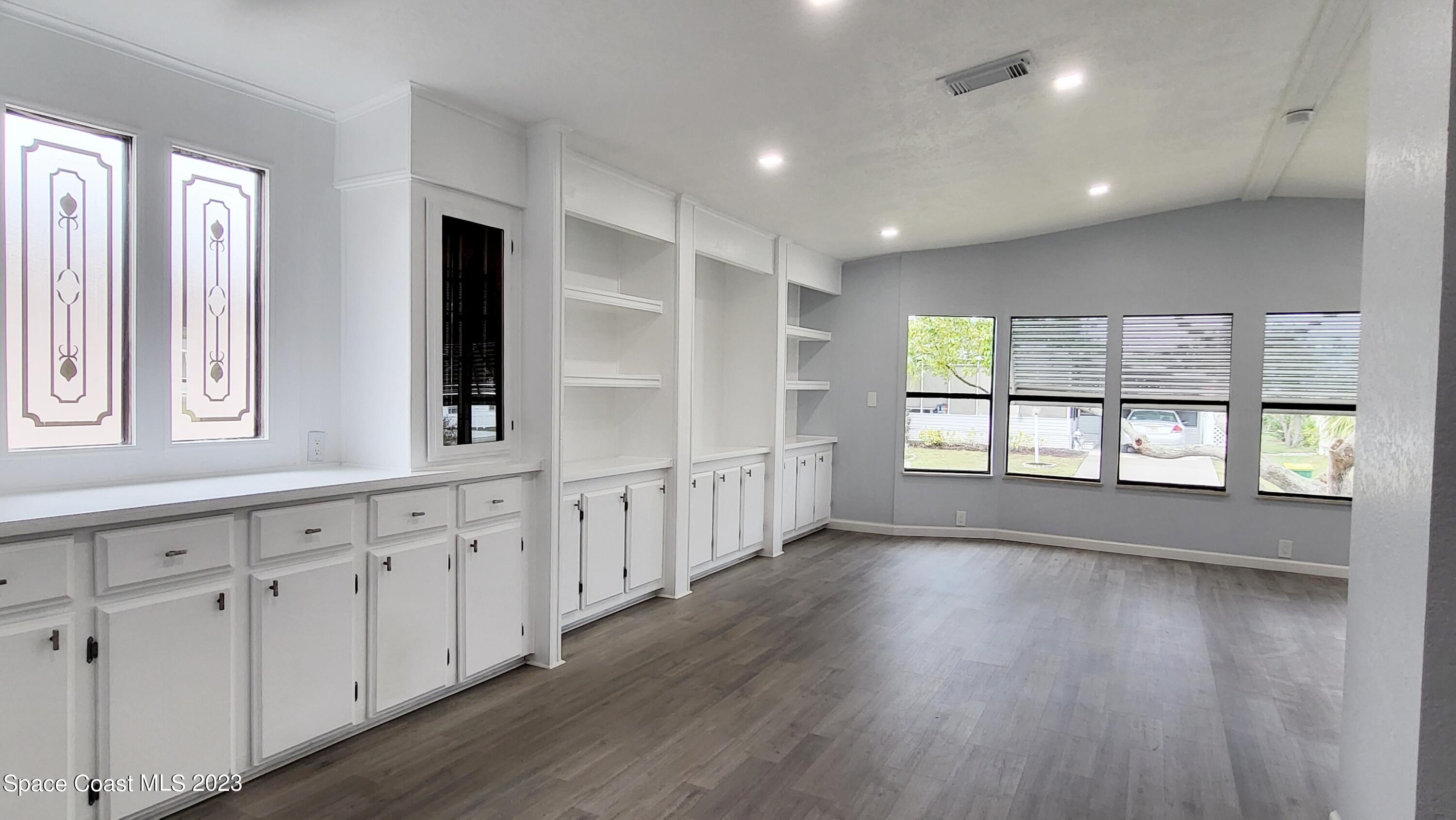 313 Kiwi Drive Sebastian, FL 32976 - Photo 9 of 31 a view of an empty room with wooden floor and a window