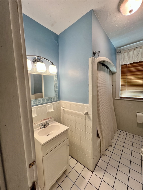 138 Fuller Street, Unit 3 Brookline, MA 02446 - Photo 14 of 27 a bathroom with a sink a toilet and mirror