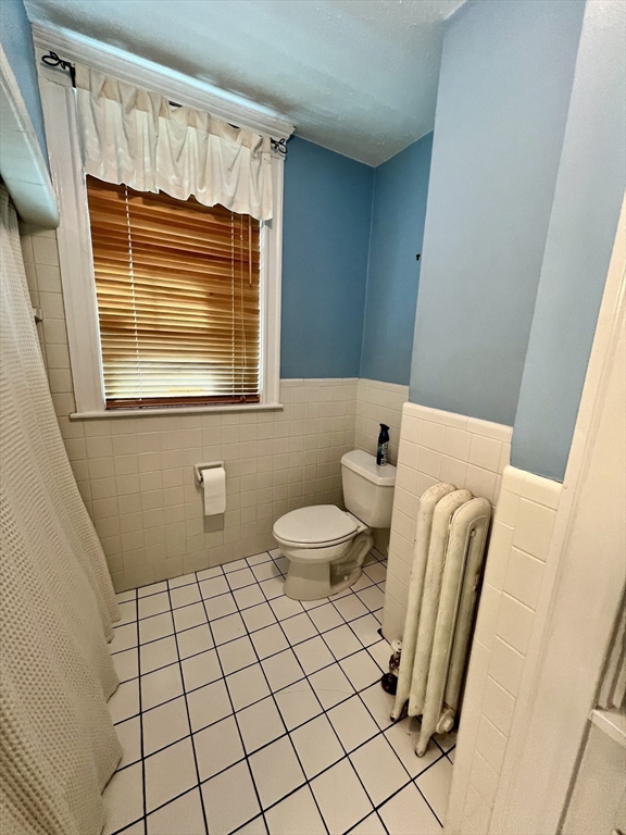 138 Fuller Street, Unit 3 Brookline, MA 02446 - Photo 15 of 27 a bathroom with a sink a toilet and a window